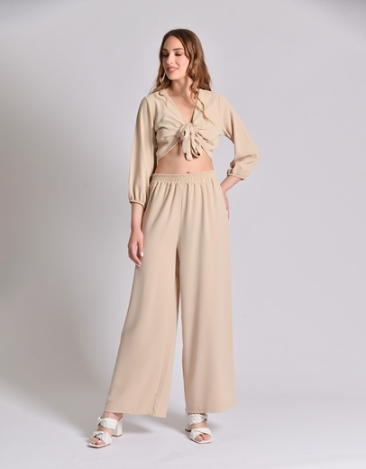 Εικόνα της Σετ μονόχρωμη παντελόνα και crop top με δέσιμο Μπεζ