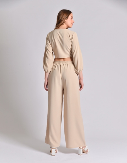 Εικόνα της Σετ μονόχρωμη παντελόνα και crop top με δέσιμο Μπεζ